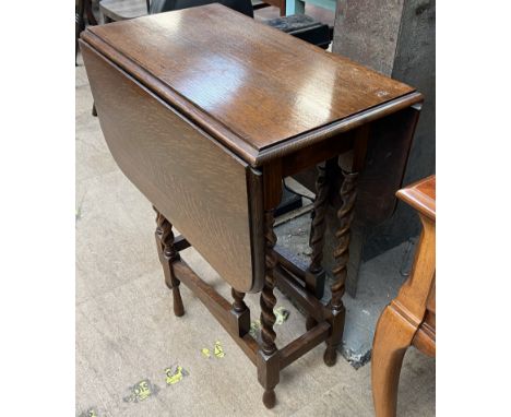 An oak gate leg table with barley twist legs