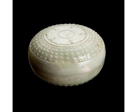 CELADON JADE CIRCULAR BOX QING DYNASTY, 19TH CENTURY supported on a short straight foot, both the domed box and cover carved 