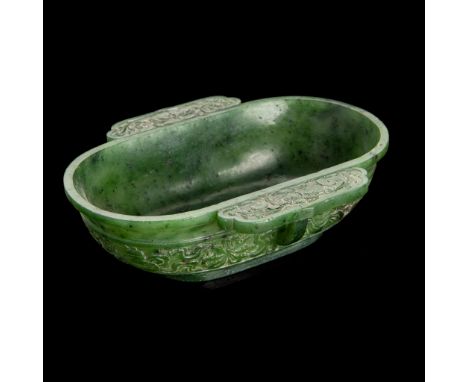 SPINACH CELADON JADE EAR CUP QING DYNASTY, 19TH CENTURY of oval shape, supported on a short straight foot, the sides flanked 