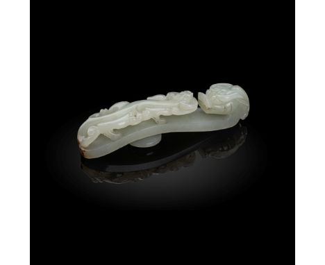 WHITE JADE 'DRAGON' BELT HOOK QING DYNASTY, 18TH-19TH CENTURY intricately carved with a horned dragon's head forming the hook