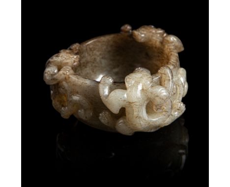 GREY AND RUSSET JADE 'CHI DRAGON' CUP MING DYNASTY carved in high relief with three chi dragons clinging on the exterior with