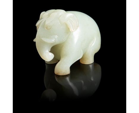 CELADON JADE CARVING OF AN ELEPHANT realistically carved marching on four feet, head straight with trunk sinuously curved lef