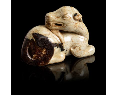 'CHICKEN BONE' JADE CARVING OF A GOAT MING DYNASTY in recumbent position with two limbs meeting in front, its head turned rig