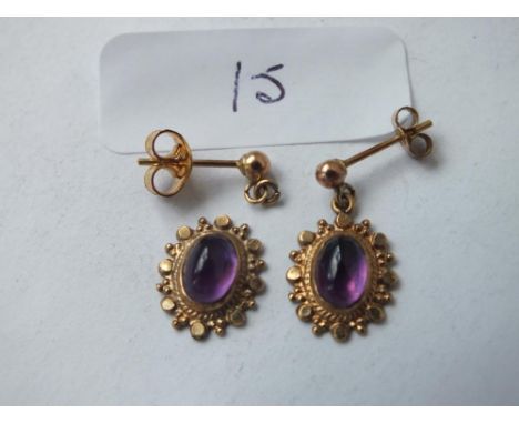 A pair of antique cabochon amethyst &amp; gold mounted ear pendants