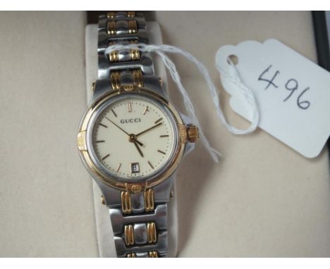 A boxed ladies GUCCI watch with papers with seconds sweep &amp; calender dail