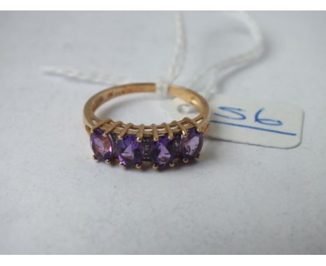 A four stone amethyst ring with diamond spacers set in 9ct - size P - 2.3gms