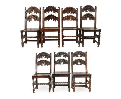 A Harlequin Set of Seven Late 17th/Early 18th Century Joined Oak Back Stools, each with scrolled and carved double crescent b