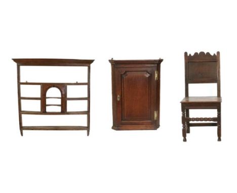 A George II Oak and Mahogany-Crossbanded Delft Rack, mid 18th century, the bold cornice above fixed shelves all around a cent