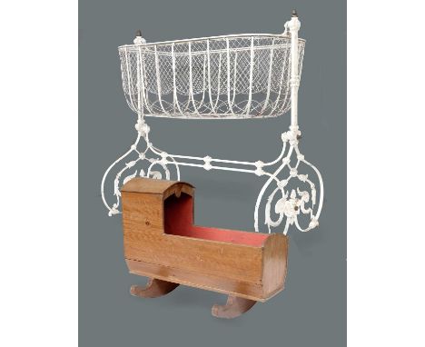 A Victorian Cast and Wrought Iron Child's Cot, possibly Coalbrookdale, later painted white, the pivoting basket with wirework