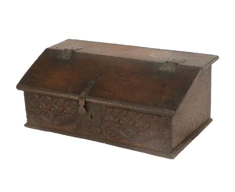 A Late 17th/Early 18th Century Carved Oak Bible Box, initialled EB, the hinged lid with chip-carved border, iron hinges and c