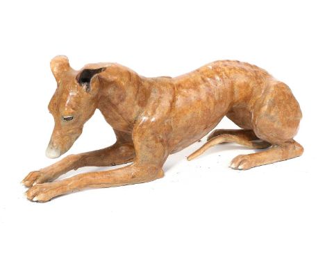 Nick Mackman SWLA (b. 1972)Life-sized recumbent whippetSigned, crackle glazed ceramic, 62cm longRear right leg and end of tai