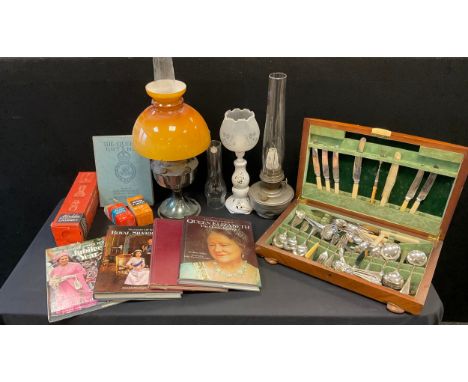 A canteen of Old English flatware;  an EPNS preserve spoon;   pickle forks;  paraffin and oil lamps; ; commemorative books - 
