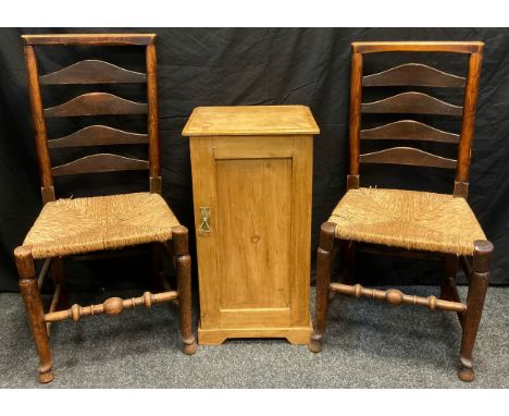 A pair of early 19th century oak and elm, country ladder-back kitchen chairs, rush seats, turned legs and stretchers;  a pine