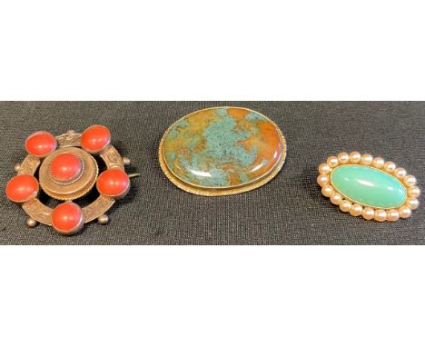 A 9ct mounted polished hardstone oval brooch, 3.5cm diam;  a coral mounted target brooch;  a 9ct gold oval turquoise coloured