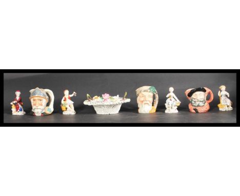 A group of four Sitzendorf ceramic figures along with three Royal Doulton Character jugs and a Crown Stafford flower basket. 