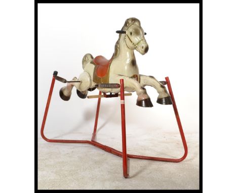 A vintage 1960's retro tin pressed metal MOBO rocking horse. Original labels with good colours remaining to horse and sprung 