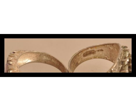 A group of vintage silver white metal rings to include a hallmarked bark effect ring , hallmarked gypsy ring , another hallma