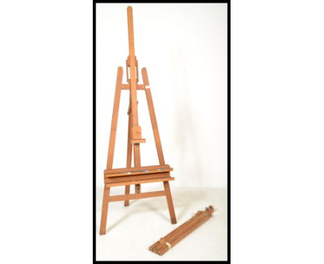 A 20th Century large wooden folding artists easel stand together with a similar one of smaller proportions.&nbsp;Measures: 18