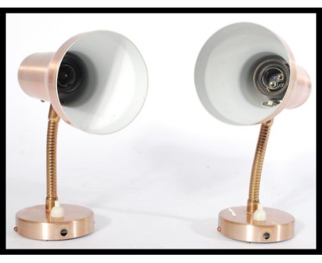 A pair of vintage mid 20th Century copper spun wall / bedroom spot lights having circular bases spun shades raised on a goose