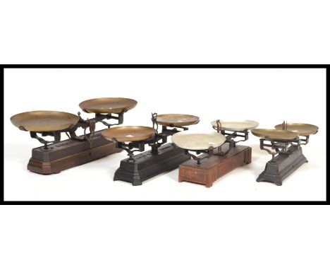 A set of three vintage early 20th Century pan scales, set to heavy cast bases.