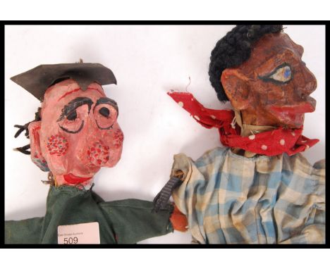 A pair of 1920's antique vintage paper mache handmade hand puppets, one in the form of a school teacher / headmaster and the 