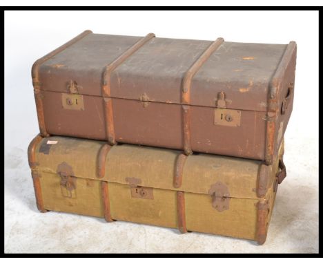 Two vintage 20th Century canvas and cane bound steamer trunks, both fitted with locks and latches to the front.Measures: 33 c