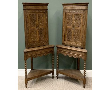 PAIR OF ANTIQUE OAK CARVED CORNER CUPBOARDS on tripod stands with lower shelf and on bobbin supports, 173cms H, 80cms W, 44cm