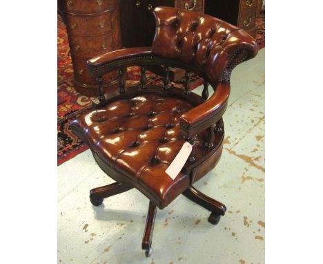 REVOLVING DESK CHAIR, tan hide leather upholstered with deep button back and seat revolving and reclining on an adjustable ba