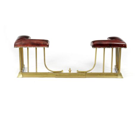 A BRASS ADJUSTABLE CLUB FENDER FIRST HALF 20TH CENTURY with maroon leather seats and with railed supports 47.2cm high, 172cm 