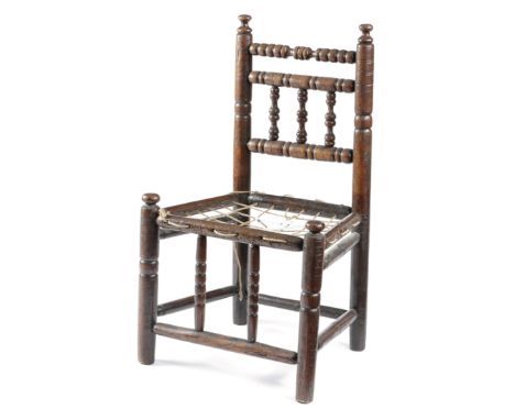 A CHARLES II OAK TURNER'S CHILD'S CHAIR LATE 17TH CENTURY AND LATER the turned spindle and bobbin back above a later rope sea