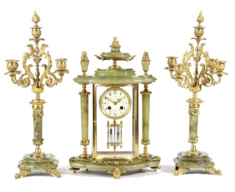 A FRENCH ONYX AND ORMOLU CLOCK GARNITURE LATE 19TH / EARLY 20TH CENTURY the brass eight day drum movement with an outside cou