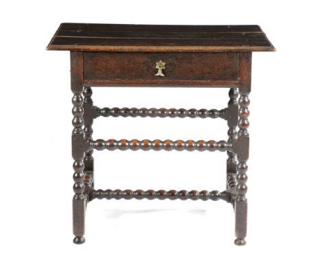 A WILLIAM AND MARY OAK SIDE TABLE C.1690 the boarded top with a moulded edge, above a frieze drawer, on bobbin turned and blo