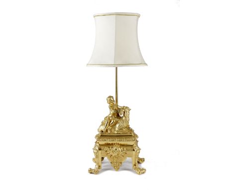 A FRENCH ORMOLU TABLE LAMP IN LOUIS XV STYLE modelled with a young girl feeding a goat, on a classical sarcophagus base, with