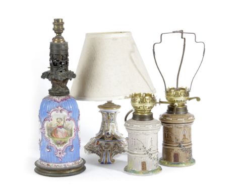 FOUR CERAMIC TABLE LAMPS 19TH CENTURY including: two similar in the form of Gothic cylindrical castles, one with a shade (4) 