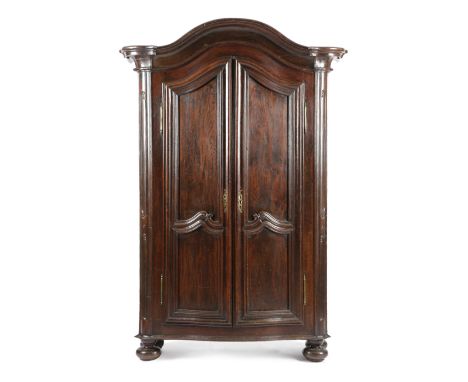 A FRENCH PROVINCIAL CHESTNUT ARMOIRE 18TH CENTURY of arched form, with moulded scroll decoration, with a pair of panelled doo