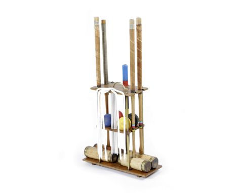 A CROQUET SET ON STAND FIRST HALF 20TH CENTURY with four mallets, three by Spalding and an associated one by Jaques, with hoo