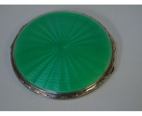 Silver and green enamel compact with shell design to the front