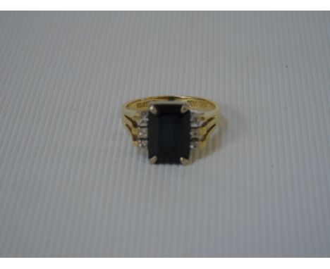 18ct Large oblong sapphire and 6 diamond ring