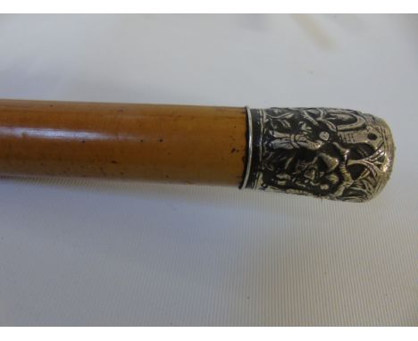Metal top walking stick decorated with oriental men. Approx 36"