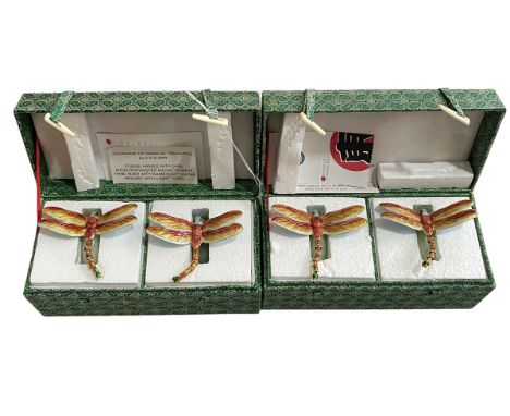 Two boxes with 'Oriental Treasures' jade and enamel napkin rings, four pieces.