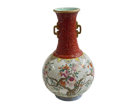 Chinese famille rose vase decorated with trees, iron red neck and gilt handled, red seal mark to base, 26cm.