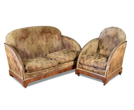 An Art Deco walnut framed three piece suite, comprising two-seater sofa and two armchairs, each with shaped back to downswept