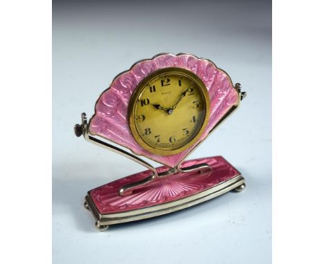 A George V silver and guilloché enamel dressing table clock, Birmingham 1928, the fan-shaped timepiece with brass dial raised
