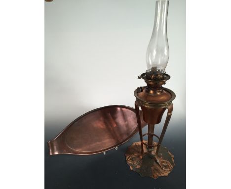 A Birmingham Guild of Handicraft copper oil lamp, the lamp supported on three elongated shaped feet to a spreading scalloped 