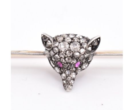 A gold and diamond fox brooch pin cased. The gold brooch pin having a central fox head encrusted with pave set old cut diamon
