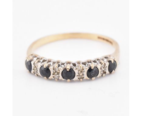 A hallmarked 9ct gold sapphire and diamond half hoop ring. The 9ct yellow gold ring set with five round cut sapphires intersp