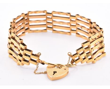 A hallmarked 9ct gold gate link bracelet with heart padlock clasp and safety chain. Hallmarked for London, 1980. Sponsor's ma