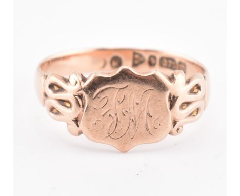 A hallmarked 9ct gold shield signet ring. The 9ct rose gold signet ring having an engraved shield head to fluted shoulders an