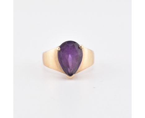 A hallmarked 9ct gold and Uruguayan amethyst ring. The 9ct yellow gold ring set with a single pear cut Uruguayan amethyst to 