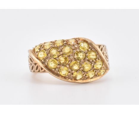 A hallmarked 9ct gold and yellow sapphire dome ring. The 9ct yellow gold dome ring set with 19 pave set round cut yellow sapp